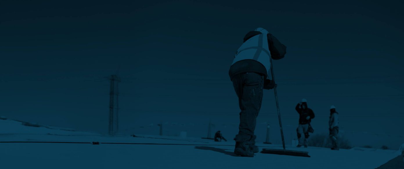 gentleman using broom on roof with dark blue overlay