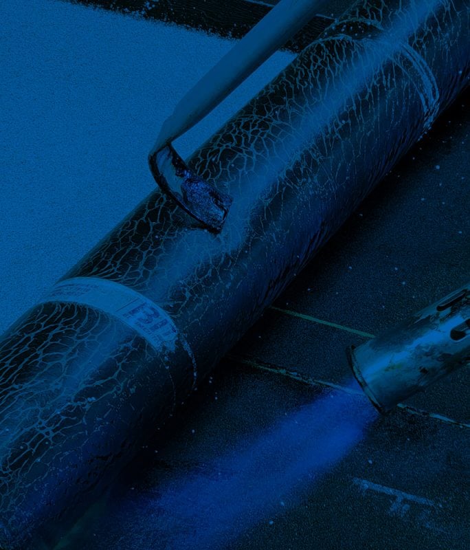 surface being treated with a roller and spraying system with dark blue overlay
